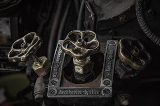 Antique brass valves with inscriptions in the controls of a locomotive, Dahlhausen railway depot,