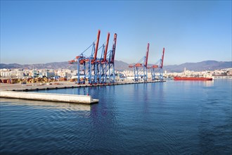 Cranes standing on quayside in the port of Malaga, Spain, Europe