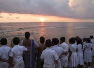 School group on fort ramparts at sunset in historic town of Galle, Sri Lanka, Asia