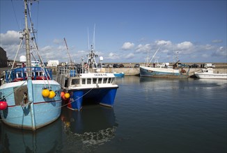Boats in the harbour at Seahouses, Northumberland, England, UK