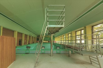An abandoned swimming pool with a slide and a green-yellow colour scheme, Bad am Park, Lost Place,
