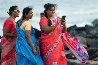 Indian women in saris on the beach, promenade, former French colony Pondicherry or Puducherry,