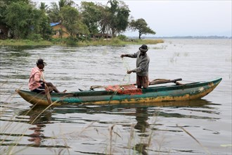 Men fishing from a canoe, Polonnaruwa, Central Province, Sri Lanka, Asia