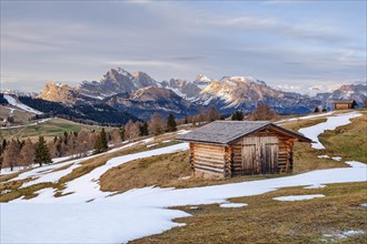 Alpine hut with snow, spring on the Seiser Alm, Seceda, Dolomites, South Tyrol
