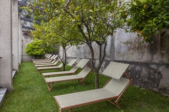 Sun loungers under orange trees, Limone sul Garda, Lake Garda, Italy, Europe
