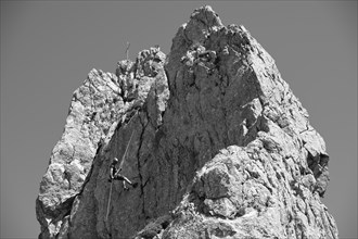 Climber abseiling on the Rosssteinnadel, mountaineering village Kreuth, Mangfall mountains,