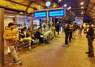 People waiting for the train on the platform in the evening, Central Station, Krefeld, North