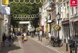 People walking and cycling in historic street central Utrecht, Netherlands