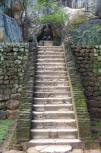 People climbing steps of stone staircase to the rock palace at Sigiriya, Central Province, Sri