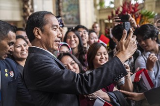 Joko Widodo, the President of Indonesia, takes selfies during a visit to Manila, Philippines