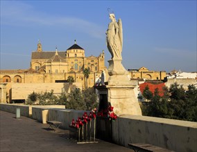 Angel San Rafael statue on Roman bridge with views cathedral, Cordoba, Spain, Europe