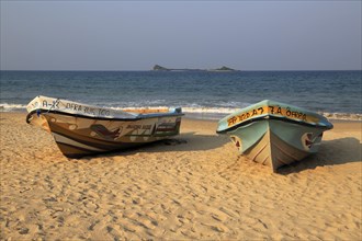 Boats on tropical beach at Nilavelli, Trincomalee, Sri Lanka, Asia with Pigeon Island in
