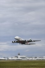 Emirates Airways Airbus A380-800 take-off on southern runway with control tower, Munich Airport,