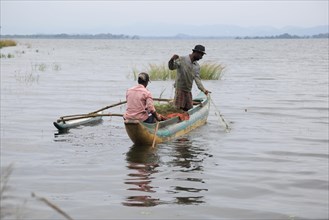 Men fishing from a canoe, Polonnaruwa, Central Province, Sri Lanka, Asia