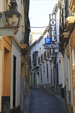Hotel Omegas sign historic buildings in narrow street in old city centre of Cordoba, Spain, Europe