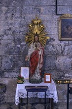 Chistus figure with sacrificial candles in the church of San Donato, 12th century, Via S. Donato,