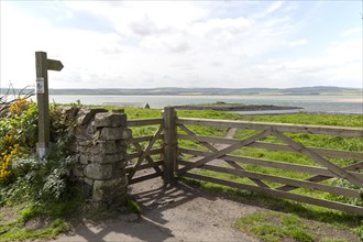 Footpath sign and gateway Holy Island, Lindisfarne, Northumberland, England, UK