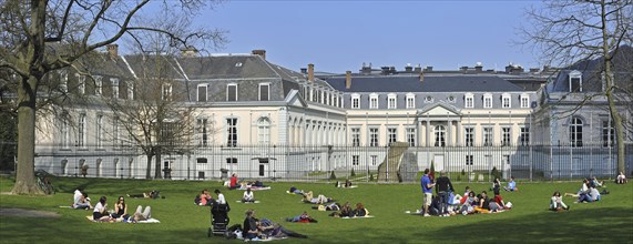 Tourists sunbathing in park at the Egmont Palace, Egmontpaleis, Palais d'Egmont in Brussels,