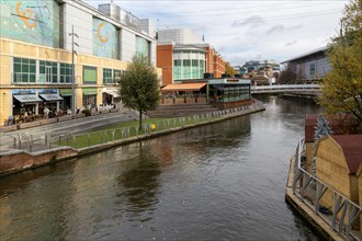 River Kennet flowing past The Oracle shopping centre in town centre, Reading, Berkshire, England,