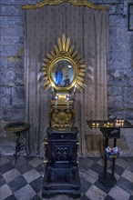 Prayer room with sacrificial candles in the church of San Donato, 12th century, Via S. Donato, 10,