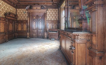 A room steeped in history with elaborate wood carvings and reflections in the window, Villa