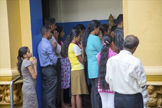 People praying Gangaramaya Buddhist Temple, Colombo, Sri Lanka, Asia