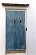 Blue doorway traditional whitewashed buildings in Vejer de la Frontera, Cadiz Province, Spain,