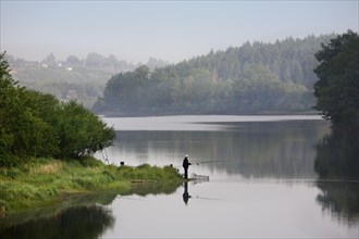 Angler at the Buetgenbach reservoir in the Hautes Fagnes, High Fens, Ardennes, Belgium, Europe