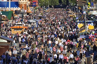 Crowds of people and visitors in the afternoon at the Oktoberfest, Munich, Bavaria, Germany, Europe