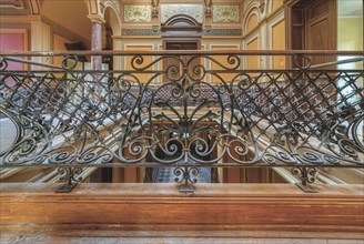 Detailed wrought-iron railing on an elegant staircase with wooden steps, Villa Woodstock, Lost