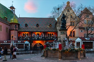 Historic house with Christmas decoration, fountain, illuminated, old department stores', Colmar,
