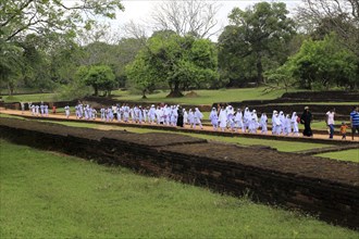 Large school group of children in the palace water gardens, Sigiriya, Central Province, Sri Lanka,