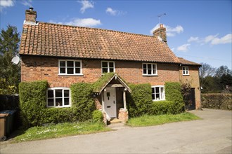Red brick detached cottage in Shottisham, Suffolk, England, UK