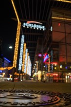 Shallow depth of field shows city lights and neon signs at night, Schloessle Galerie, Pforzheim,