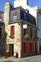 Rue du General de Gaulle in the old town centre of Le Faou with slate-roofed granite houses from
