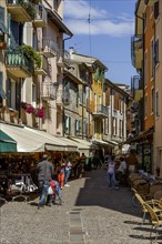 Old town alley with shops and alleyway cafe, Garda, Lake Garda, Veneto, Province of Verona, Italy,