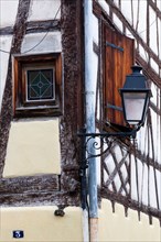 Street lamp on a historic half-timbered house, Colmar, Alsace, France, Europe