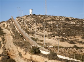 Security fence and look-out tower of military base in Melilla autonomous city state Spanish