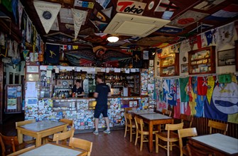 Interior view of the famous Cafe Sport with many flags and pennants from Atlantic crossings on the