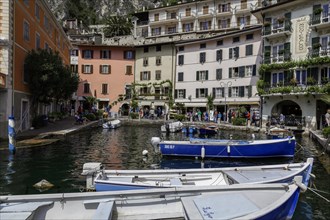 Houses and fishing boats in the old harbour of Limone sul Garda, Lake Garda, Province of Brescia,