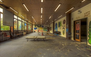 An abandoned hallway with colourful graffiti, destroyed furniture and glass windows, Biotech,