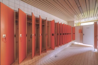 A set of red changing cubicles in a clean, empty room, Bad am Park, Lost Place, Essen, North