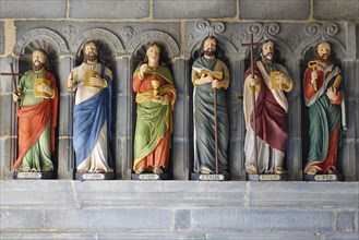 Six statues of saints in a restored version in front of the entrance to the Saint-Sauveur church on