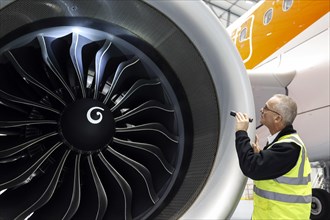Olaf Gross, Licence Engineer at easyJet, checks the engine of an Airbus A320 Neo in front of the