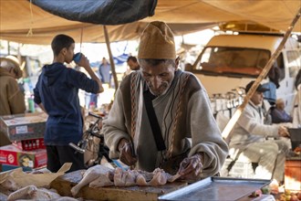 Man cutting up meat, weekly market market, Ourika, Morocco, Africa