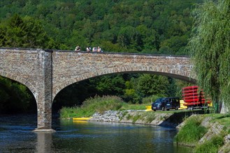 Bridge with tourists looking over the Semois river in summer at the village Vresse-sur-Semois,