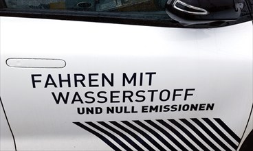 Hydrogen slogan Driving with hydrogen and zero emissions on a hydrogen-powered vehicle, Berlin, 11