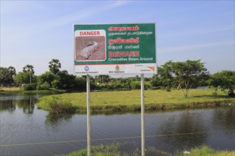 Danger sign warning of crocodiles, Pasikudah Bay, Eastern Province, Sri Lanka, Asia