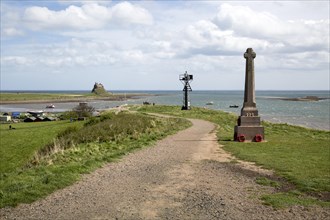 War memorial and castle, Holy Island, Lindisfarne, Northumberland, England, UK