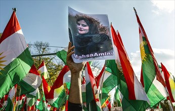 A picture of Mahsa Amini is shown at a demonstration in Berlin. Thousands of Iranians protest in
